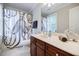 Clean bathroom featuring a spacious vanity, octopus-themed shower curtain, and a window at 663 Clifton Ne Rd, Atlanta, GA 30307
