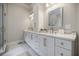 Elegant bathroom with double sink vanity, white marble counters, and gold hardware at 663 Clifton Ne Rd, Atlanta, GA 30307