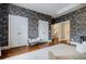 Spacious bedroom featuring a decorative accent wall, hardwood floors, and recessed lighting at 663 Clifton Ne Rd, Atlanta, GA 30307