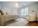 Bright bedroom with a ceiling fan, carpet, and sitting chair by the windows at 663 Clifton Ne Rd, Atlanta, GA 30307