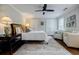Bright bedroom features a ceiling fan, a comfortable bed with stylish linens, and an en suite bathroom at 663 Clifton Ne Rd, Atlanta, GA 30307