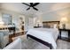 Bright bedroom features a ceiling fan, a comfortable bed with stylish linens, and an en suite bathroom at 663 Clifton Ne Rd, Atlanta, GA 30307