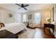 Bright bedroom with a ceiling fan, carpet, two sitting chairs, and a writing desk by the windows at 663 Clifton Ne Rd, Atlanta, GA 30307
