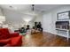 A bonus room featuring hardwood floors, a cozy sectional sofa, and a classic rocking chair for added comfort at 663 Clifton Ne Rd, Atlanta, GA 30307
