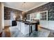 Open concept dining room with stylish wallpaper, modern lighting, and adjacent kitchen at 663 Clifton Ne Rd, Atlanta, GA 30307
