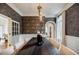 Dining room with striking wallpaper, modern chandelier, and natural light from large window at 663 Clifton Ne Rd, Atlanta, GA 30307
