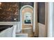Open dining room with dark wallpaper, white trim, and access to other living spaces through arched doorway at 663 Clifton Ne Rd, Atlanta, GA 30307