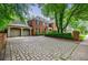 Paver driveway leads to a brick home with an attached garage, offering ample parking and classic charm at 663 Clifton Ne Rd, Atlanta, GA 30307