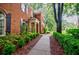 Side view of a brick house with a sidewalk and manicured bushes at 663 Clifton Ne Rd, Atlanta, GA 30307