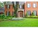 Charming brick home boasts manicured landscaping, black shutters, and a welcoming front door, creating a picture perfect facade at 663 Clifton Ne Rd, Atlanta, GA 30307