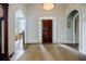 Grand foyer featuring hardwood floors, elegant archways, and a glimpse into the bright and inviting living spaces at 663 Clifton Ne Rd, Atlanta, GA 30307
