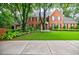 Well maintained lawn and meticulous landscaping frame a brick home with black shutters, exuding timeless elegance at 663 Clifton Ne Rd, Atlanta, GA 30307