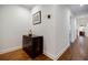 Hallway featuring hardwood floors, a decorative cabinet, and neutral-toned walls that lead to an open space at 663 Clifton Ne Rd, Atlanta, GA 30307