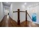 Bright hallway featuring hardwood floors, white trim, and a staircase with modern chandelier at 663 Clifton Ne Rd, Atlanta, GA 30307