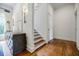 Hallway featuring hardwood floors, a stylish console table, and an adjacent staircase at 663 Clifton Ne Rd, Atlanta, GA 30307