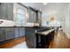 Gourmet kitchen with gray cabinets, stainless steel appliances, and island with seating at 663 Clifton Ne Rd, Atlanta, GA 30307