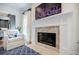 Bright living room featuring a fireplace, comfortable chair, and blue-patterned rug at 663 Clifton Ne Rd, Atlanta, GA 30307