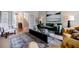 Open-concept living room with hardwood floors, a green sofa, and plenty of natural light at 663 Clifton Ne Rd, Atlanta, GA 30307