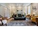 Comfortable living room with a green sofa, mirrored coffee table, and coffered ceiling at 663 Clifton Ne Rd, Atlanta, GA 30307