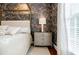 Close-up of a main bedroom featuring elegant decor, neutral tones, and a bedside table at 663 Clifton Ne Rd, Atlanta, GA 30307
