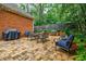 Charming brick home backyard patio with ample seating, outdoor grill, and lush landscaping at 663 Clifton Ne Rd, Atlanta, GA 30307