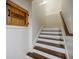 Stairway featuring painted risers, wooden treads, and a crawl space with a unique door design at 663 Clifton Ne Rd, Atlanta, GA 30307