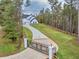 Aerial shot showcasing a gated entry, long driveway, and beautifully landscaped yard at 1387 Mineral Springs Rd, Hoschton, GA 30548