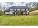 Expansive backyard featuring a covered patio and lush green lawn, perfect for outdoor enjoyment at 1387 Mineral Springs Rd, Hoschton, GA 30548