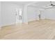 Spacious and bright bedroom features hardwood floors, tray ceilings, and neutral paint colors at 1387 Mineral Springs Rd, Hoschton, GA 30548
