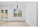 Bright dining area with large window and view of trees at 1387 Mineral Springs Rd, Hoschton, GA 30548