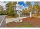Gated entrance with brick pillars and a paved driveway leading to the house through a treed lot at 1387 Mineral Springs Rd, Hoschton, GA 30548