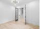 Bright entry room with light hardwood floors, modern lighting, and striking gray paneled double doors at 1387 Mineral Springs Rd, Hoschton, GA 30548
