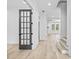 Bright foyer with light wood floors, white walls, and a modern glass door at 1387 Mineral Springs Rd, Hoschton, GA 30548