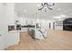 This kitchen has a large island with waterfall countertop and open floor plan with dining area at 1387 Mineral Springs Rd, Hoschton, GA 30548