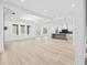 Open concept living room with recessed lights and kitchen with an island in the background at 1387 Mineral Springs Rd, Hoschton, GA 30548
