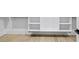 Bright walk-in closet boasts custom shelving and storage solutions with hardwood floor at 1387 Mineral Springs Rd, Hoschton, GA 30548