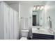 Bathroom with vanity, mirror, and shower featuring white tile and brushed nickel hardware at 5445 Whisper Ct, Cumming, GA 30028