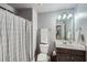 Bathroom features a shower and tub, a dark wood vanity, and a large framed mirror at 5445 Whisper Ct, Cumming, GA 30028