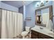 Bathroom with white shower curtain, a dark wood vanity, and a mirrored medicine cabinet at 5445 Whisper Ct, Cumming, GA 30028