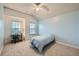 Cozy bedroom features carpet, a ceiling fan, and natural light from dual windows at 5445 Whisper Ct, Cumming, GA 30028