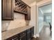 Butler's pantry with granite countertops and custom cabinetry at 5445 Whisper Ct, Cumming, GA 30028