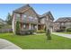 Charming two-story brick home with a well-manicured lawn and blooming flower beds at 5445 Whisper Ct, Cumming, GA 30028