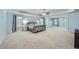 Spacious main bedroom features a tray ceiling, soft carpet, and large windows for natural light at 5445 Whisper Ct, Cumming, GA 30028
