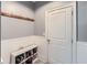 Mud room features a shoe rack, coat hooks, wainscoting, and a door leading to the exterior at 5445 Whisper Ct, Cumming, GA 30028