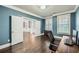 Bright office space with blue walls and rich hardwood floors at 5445 Whisper Ct, Cumming, GA 30028