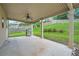 Covered patio with ceiling fan overlooks the yard, providing the perfect space for grilling at 5445 Whisper Ct, Cumming, GA 30028