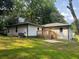 Expansive backyard featuring a wooden deck, lush green grass, and mature trees for outdoor living at 2349 Ousley Ct, Decatur, GA 30032