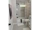 Well-lit bathroom with a shower-tub combo, gray tile backsplash and modern fixtures at 2349 Ousley Ct, Decatur, GA 30032