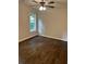 Bright bedroom featuring a ceiling fan, hardwood floors, and a large window offering natural light at 2349 Ousley Ct, Decatur, GA 30032