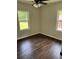 Bedroom features hardwood floors, a ceiling fan, and two large windows that let in natural light at 2349 Ousley Ct, Decatur, GA 30032